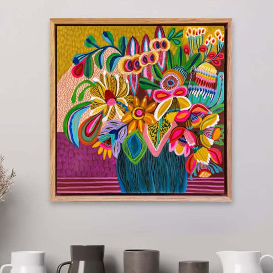 Abundant Beauty original painting by Kirsten Katz, framed on a wall above a shelf with decorative vases.