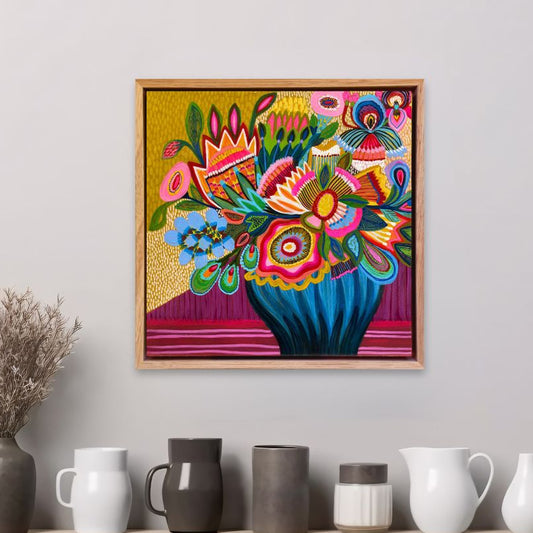 Radiant Garden original painting styled in an interior setting, colourful floral artwork by Kirsten Katz on a wall above a shelf with various ceramic items.