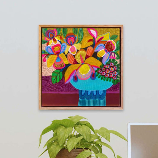 Abundant Beauty original painting by Kirsten Katz displayed on a neutral gallery-style wall on a wall above a desk with a plant and laptop.