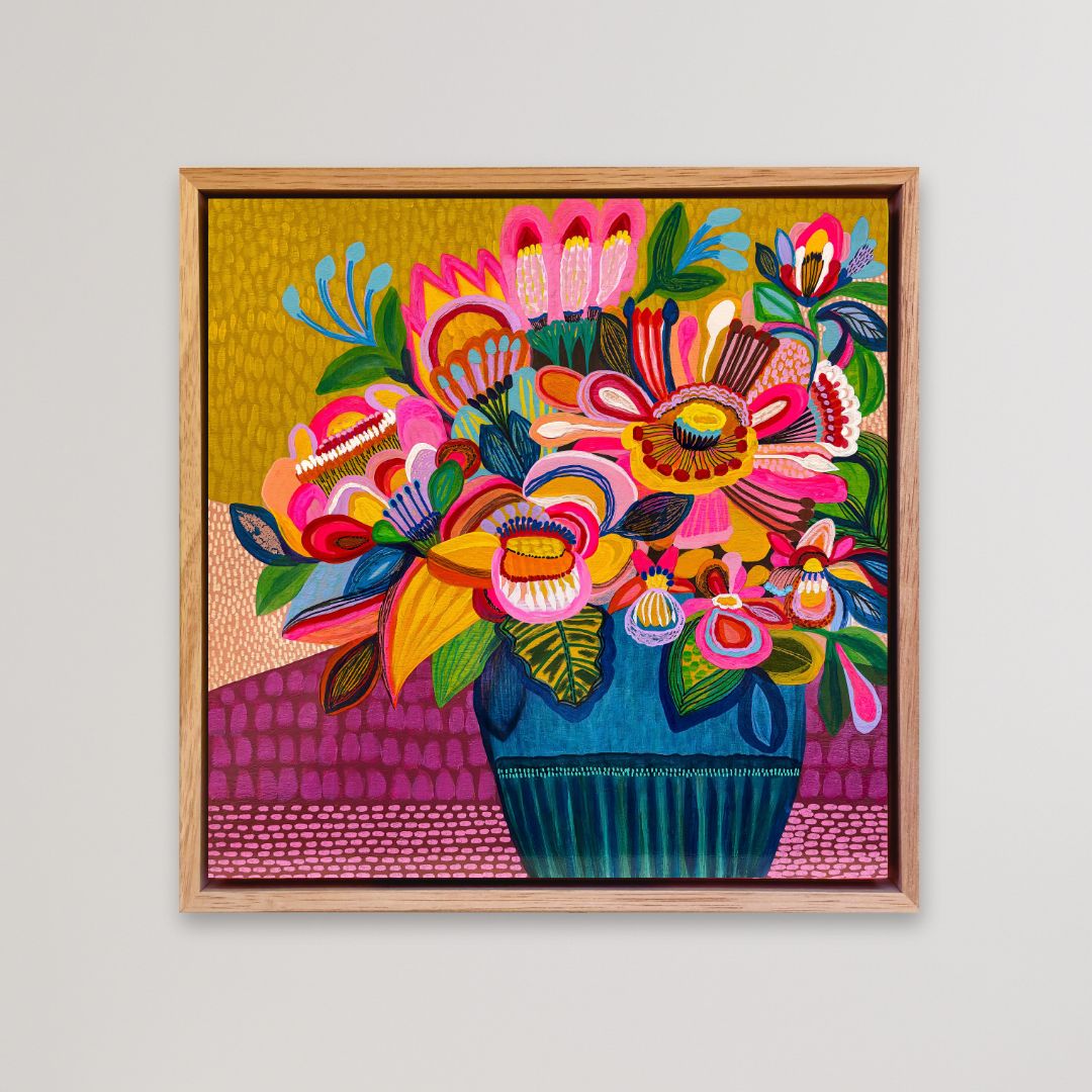 Colorful floral artwork in a wooden frame on a light gray background