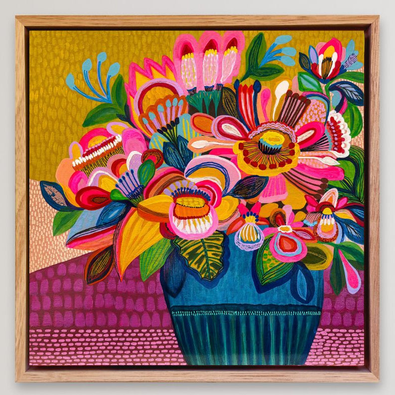 Colorful floral artwork in a wooden frame on a light gray background