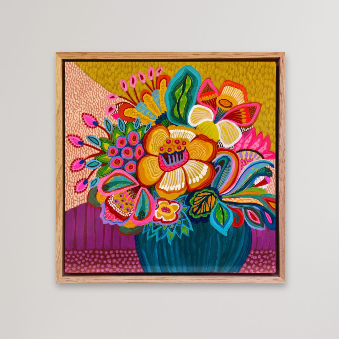 Colorful floral artwork in a wooden frame on a light gray background