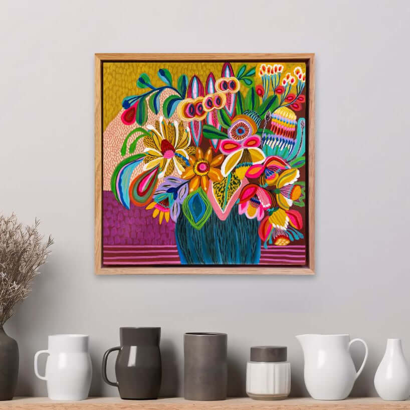 Abundant Beauty original painting by Kirsten Katz, framed on a wall above a shelf with decorative vases.