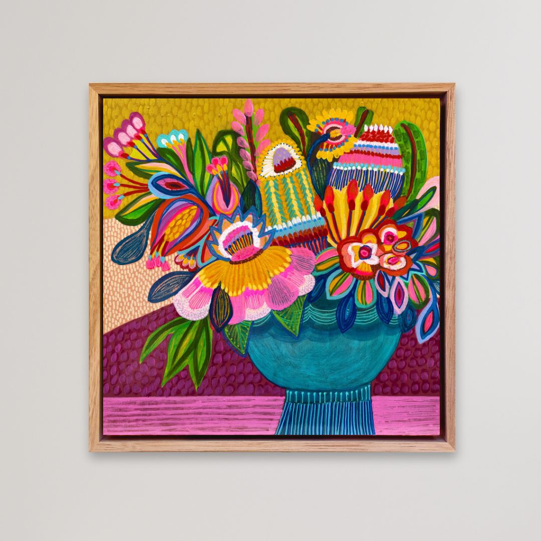 Colorful floral and abstract art piece in a wooden frame on a light gray background