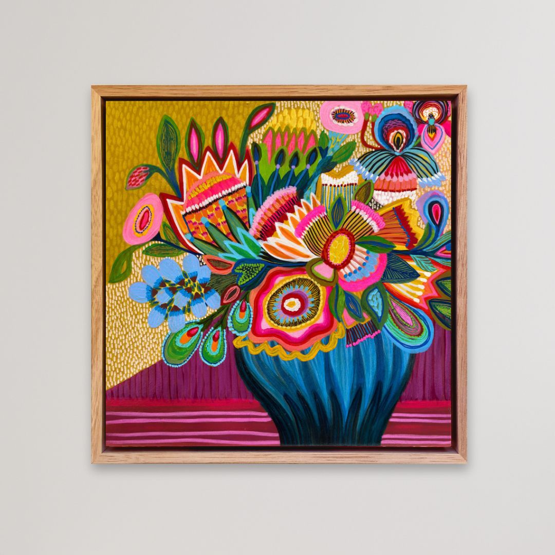 Colorful floral artwork in a wooden frame on a light gray background