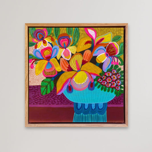 Framed colorful floral artwork on a plain background