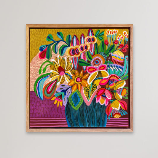 Colorful floral artwork with a wooden frame on a light gray background