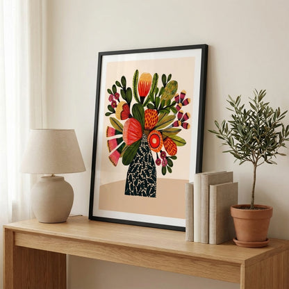 Australian bush flower wall art print framed and styled on a wooden shelf with a lamp and books.