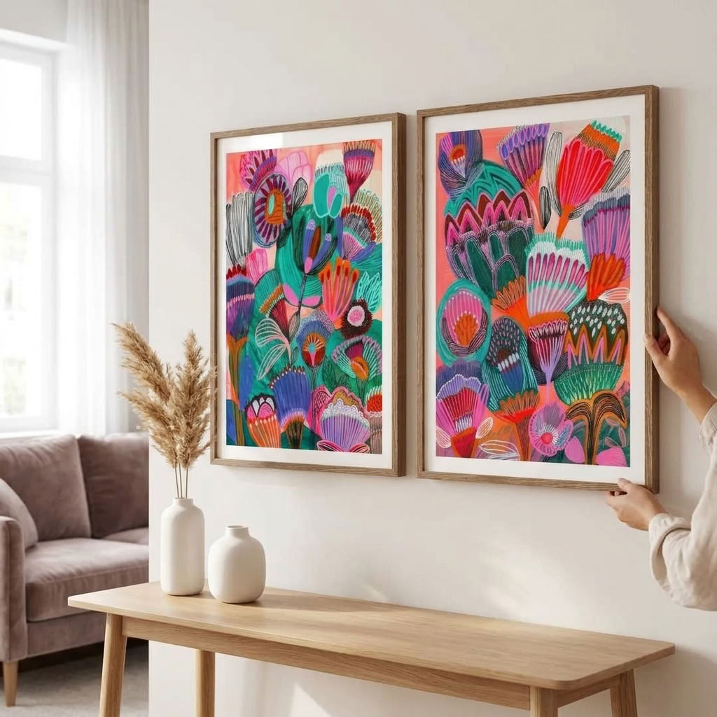 Set of two Kimberley art prints by Kirsten Katz featuring wildflowers in pink, teal and purple on warm coral