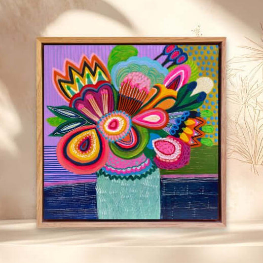Colorful abstract floral painting by Kirsten Katz in a wooden frame on a beige wall