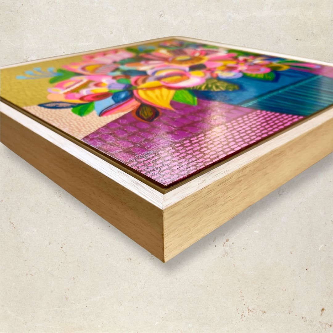 Colorful abstract artwork in a wooden frame on a light background