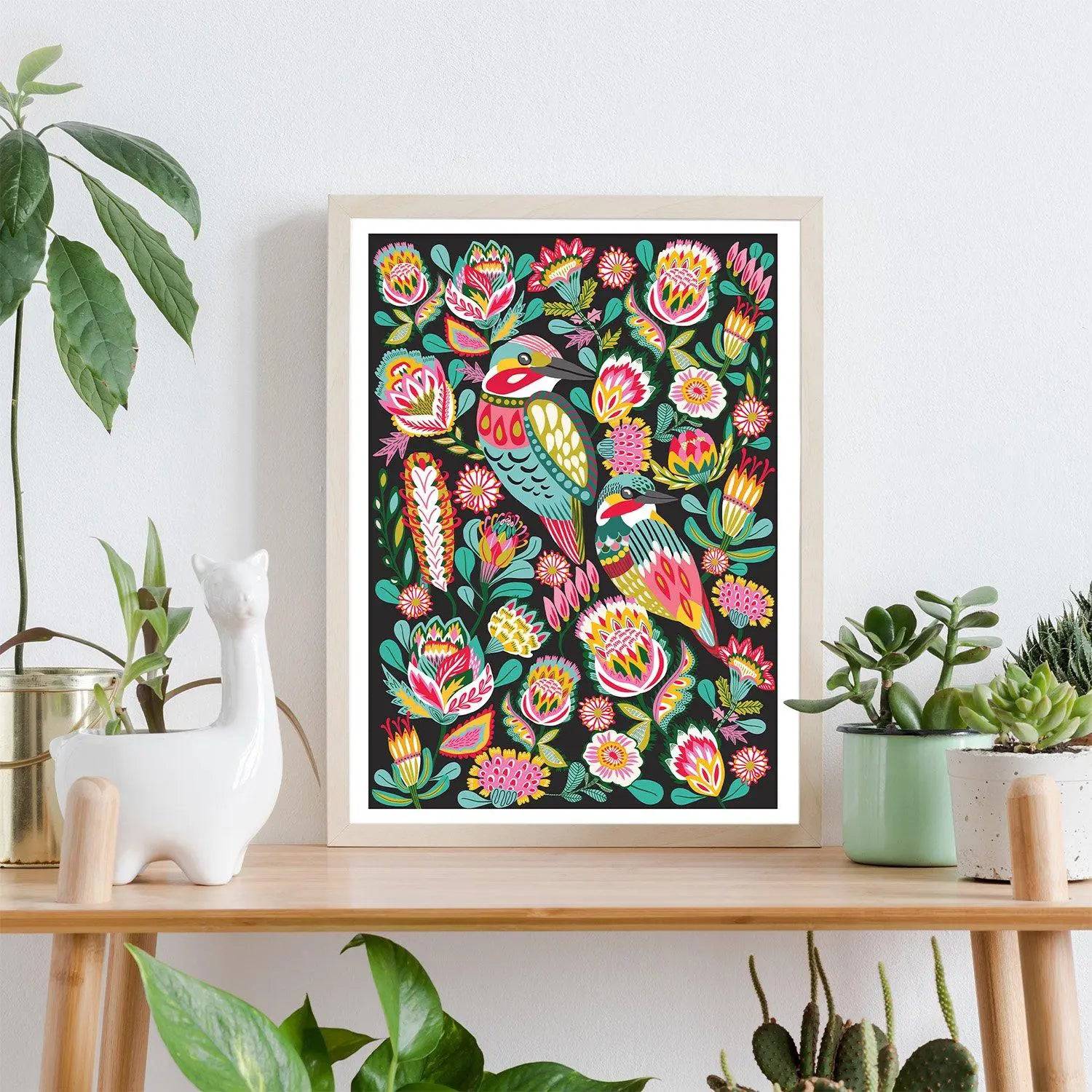 Kingfisher birds wall art print by Kirsten Katz — folk-art kingfisher among native flowers on a deep black ground